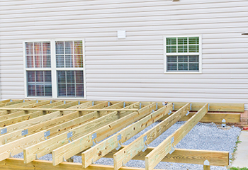 Wooden deck framing with treated beams installed in Santa Clarita backyard.